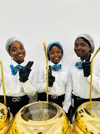 Aurelia Grace hostesses serving at a corporate event, in white shirts, gloves and hairnets.